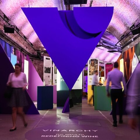 House of Vinarchy entrance in the Leake Street Tunnels showing giant logo, shopper displays and people walking between points