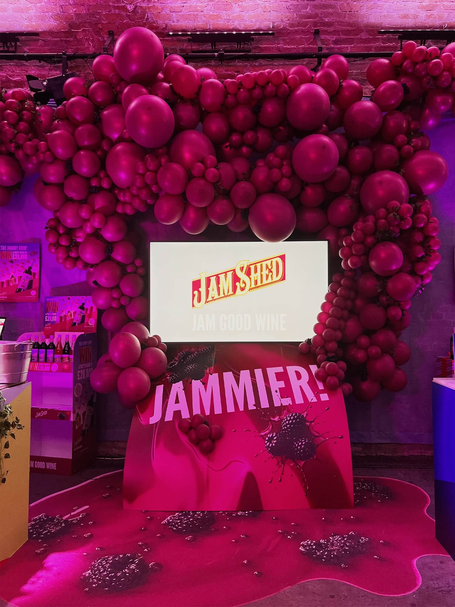 Jam shed shopper video display surrounded by a balloon arch