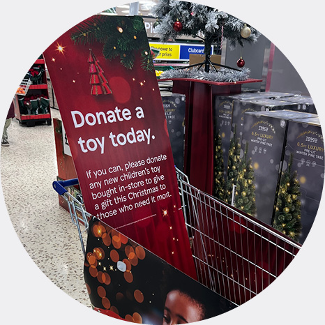 trolley advertising donation point for toys in tesco store