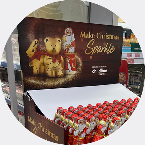 Lindt golden bears on a pallet in store advertising the charity partnership with childline and the NSPCC