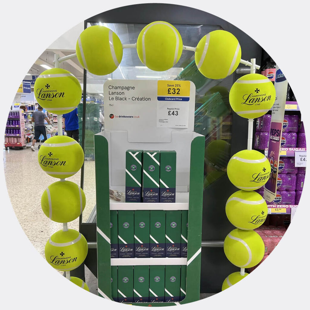 lanson wimbledon in store fixture with giant tennis balls